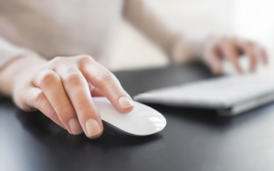 A person holding a wireless mouse